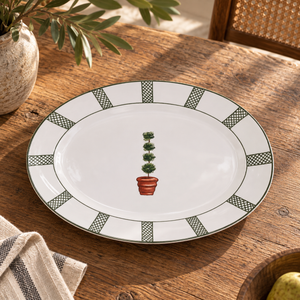 Giardino oval ceramic serving platter with a green topiary motif on a wooden table