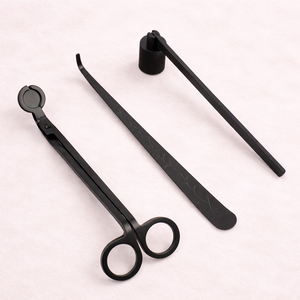 Three matte black candle care tools: wick trimmer, snuffer and dipper
