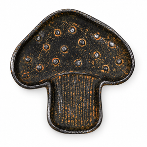 Mushroom-shaped cast iron trinket tray with a distressed black and gold finish on a white background