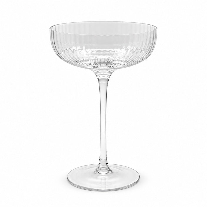 Ribbed clear coupe glass on a white background