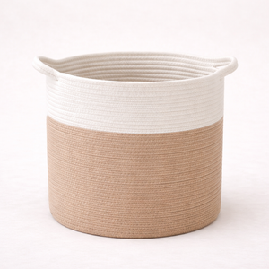 Woven basket with white top and beige bottom on a light background