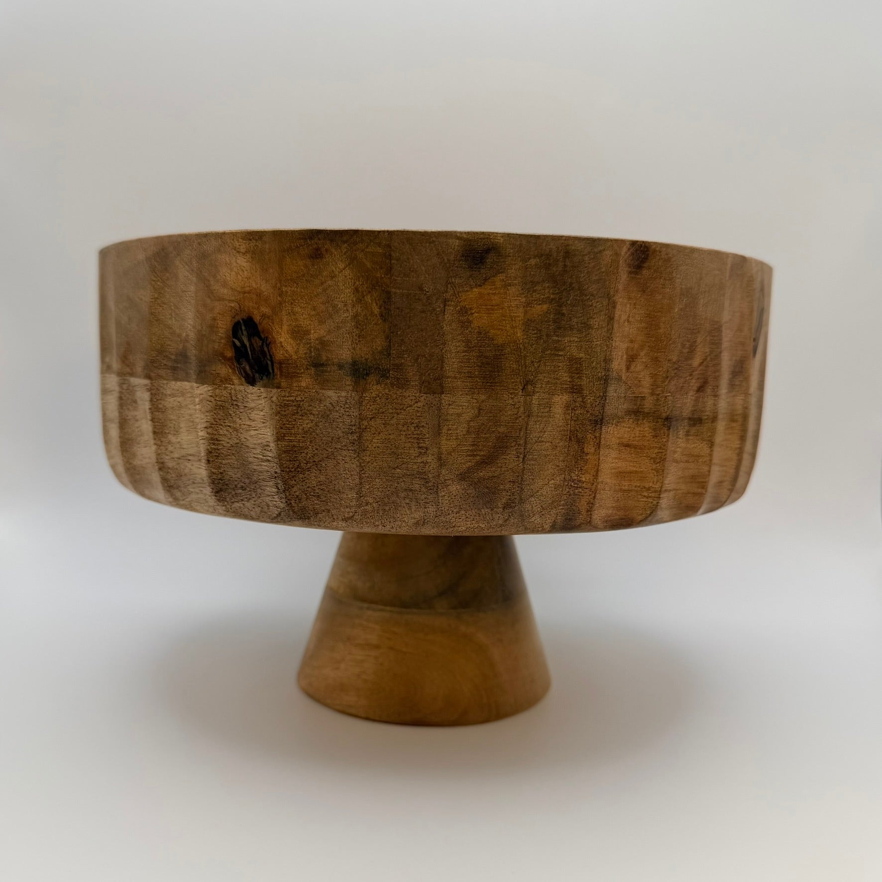 Wooden pedestal bowl with a broad bowl and flared base, side view