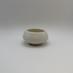 White ceramic decorative bowl with a raised base, front view