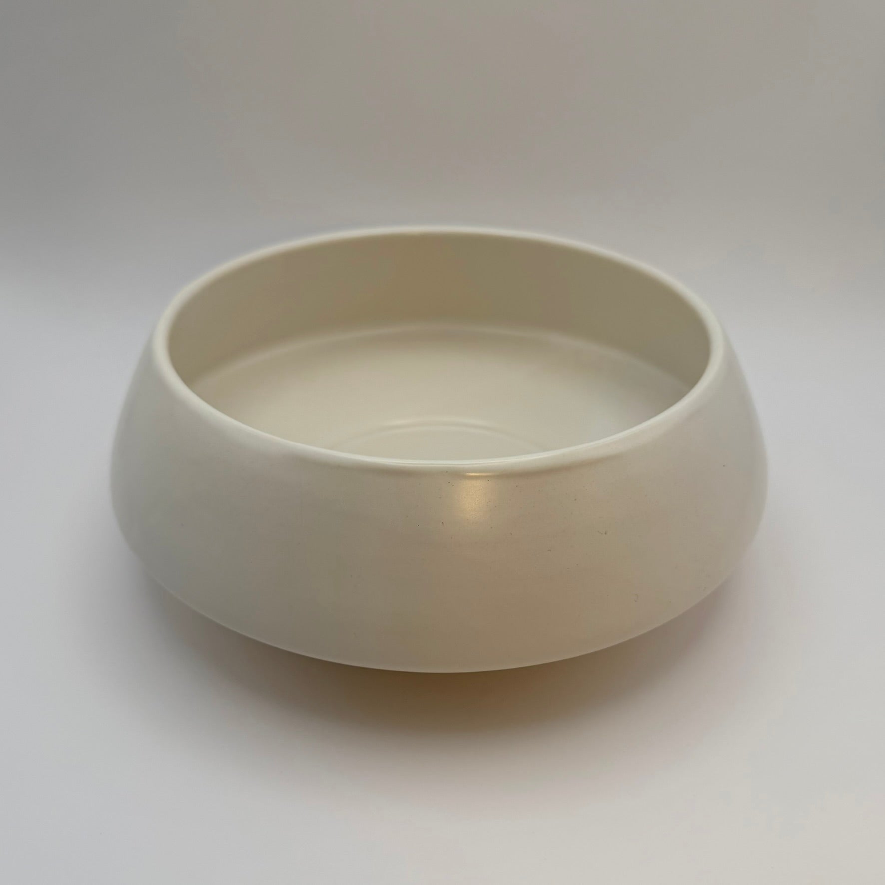 White low-profile ceramic bowl with a wide opening