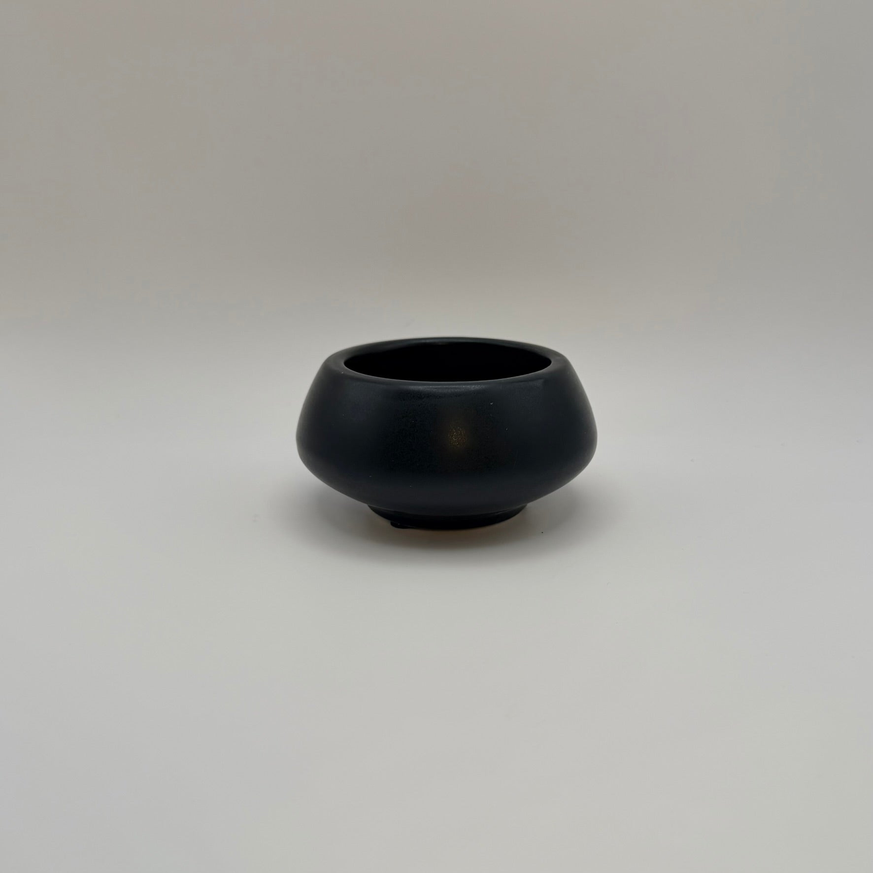 Black ceramic decorative bowl on a light background