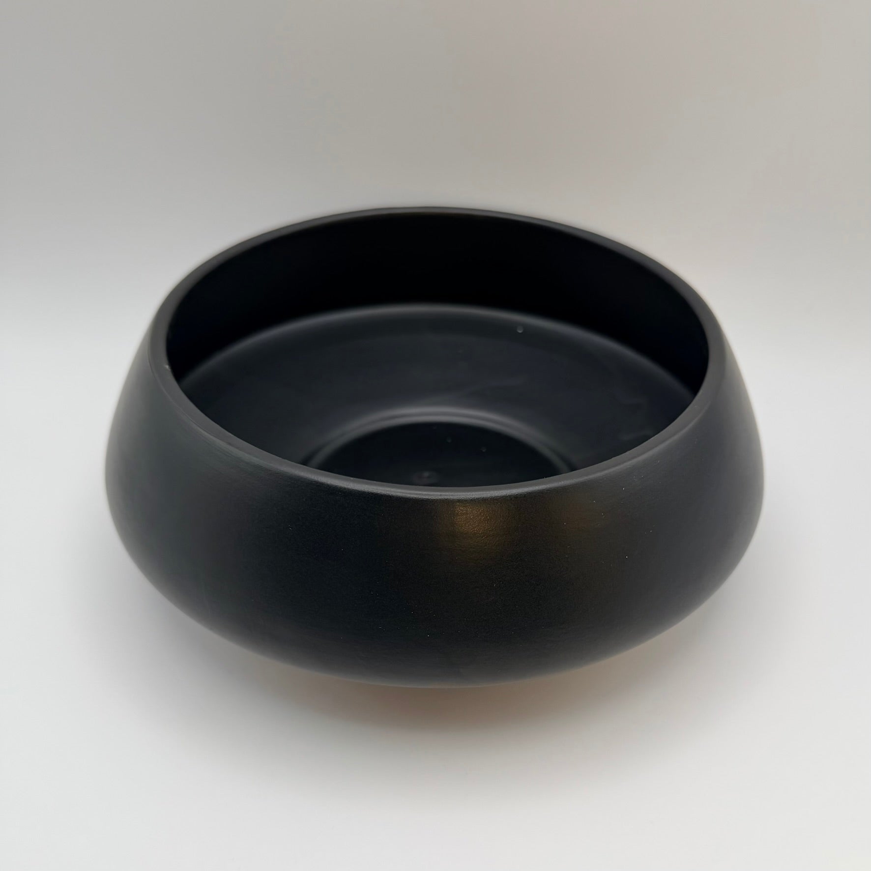 Black ceramic bowl viewed from above, showing its interior