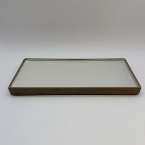 Rectangular ceramic candle tray with a pale centre and dark raised rim