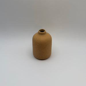 Brown sand-glazed ceramic bud vase viewed from above