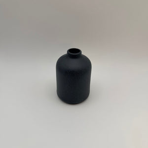 Dark gray sand-glazed ceramic bud vase viewed from above