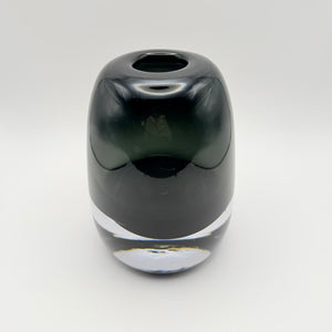 Large gray glass bud vase with a thick clear base, viewed from above