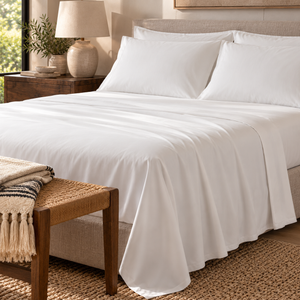 Bambusa white sheet set and pillowcases on a bed in a neutral bedroom