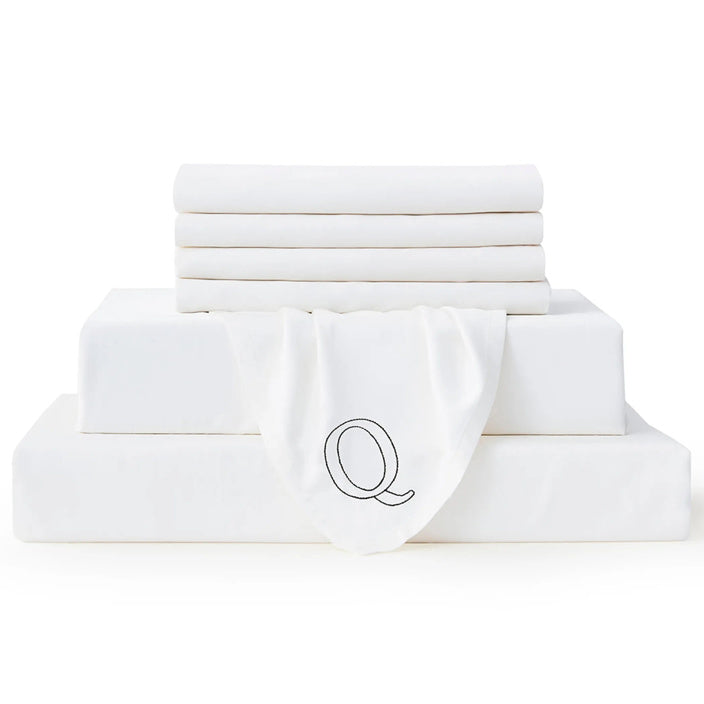 Queen-size Bambusa white seven-piece sheet set with an embroidered Q marker on a white background