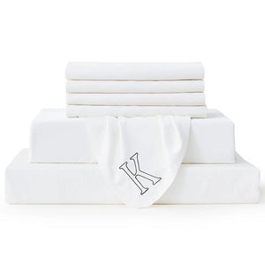 King-size Bambusa white seven-piece sheet set with an embroidered K marker on a white background